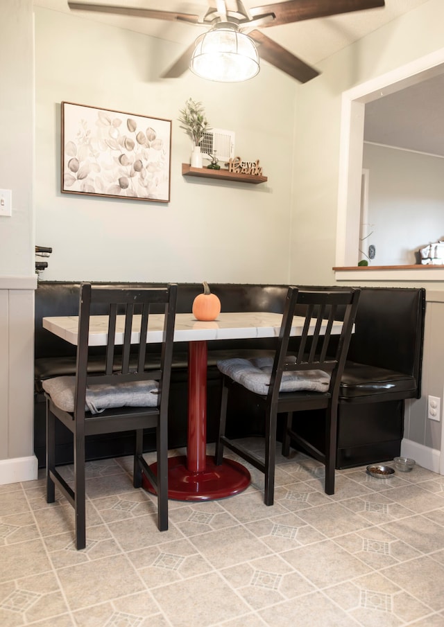 tiled dining space with ceiling fan