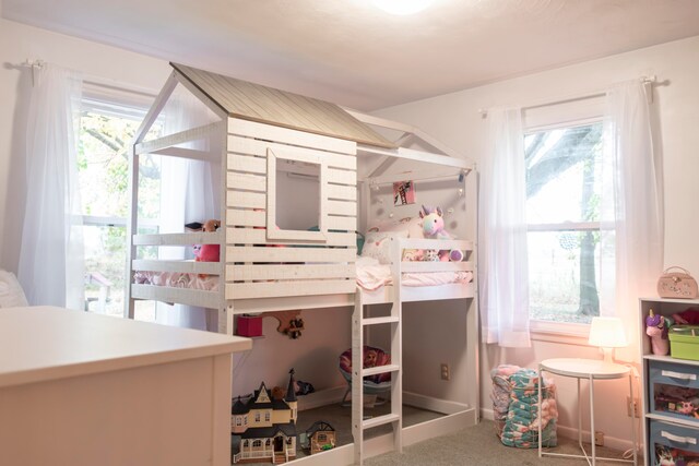 carpeted bedroom featuring multiple windows