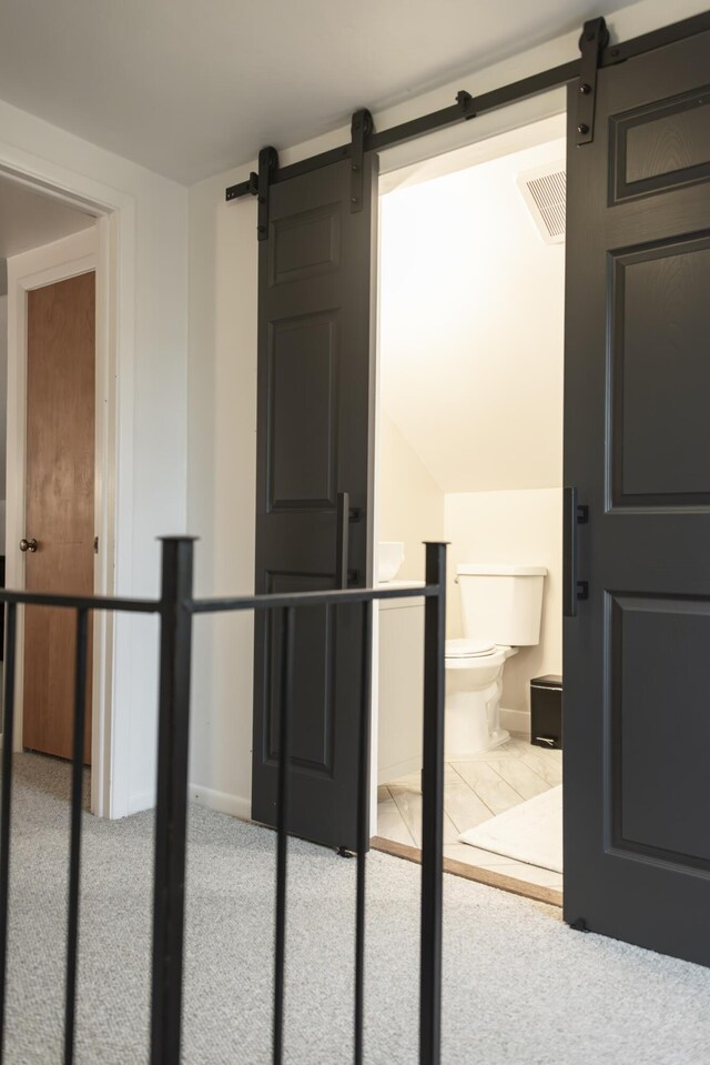 317 Maiden Ln, Saint Joseph, MI 49085 - hallway featuring a barn door, baseboards, and carpet flooring