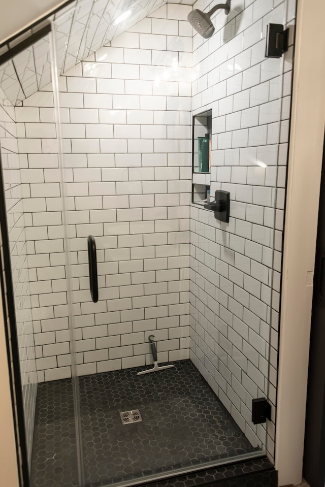 bathroom featuring a shower with door