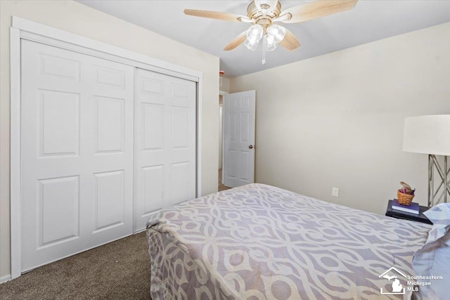 bedroom featuring dark colored carpet, a closet, and ceiling fan