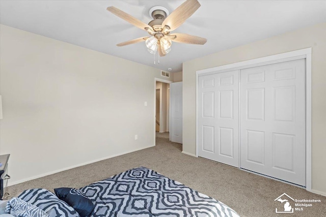 bedroom featuring carpet, a closet, and ceiling fan