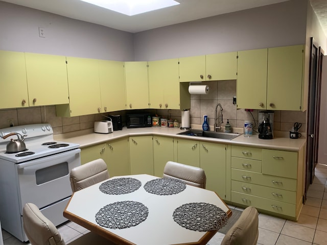 kitchen with backsplash, sink, a skylight, white electric range oven, and light tile patterned flooring