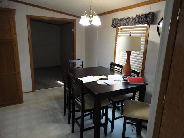 dining area featuring crown molding, a chandelier, and lofted ceiling