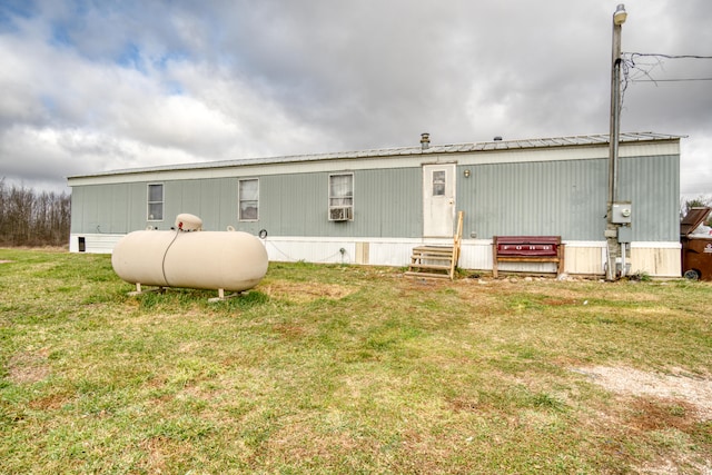 back of house with a lawn and cooling unit