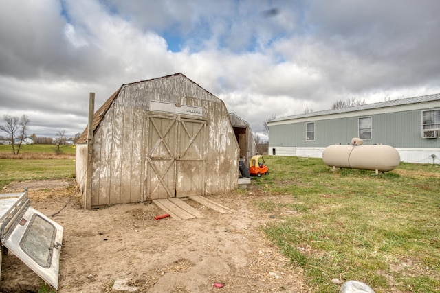 view of outdoor structure featuring a lawn