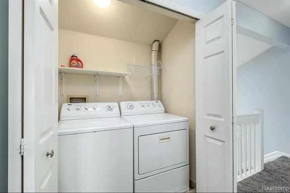 laundry area featuring separate washer and dryer and carpet