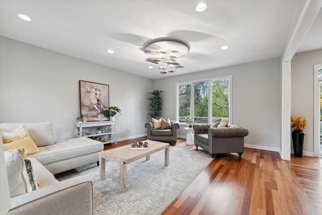 living room featuring ceiling fan and hardwood / wood-style floors