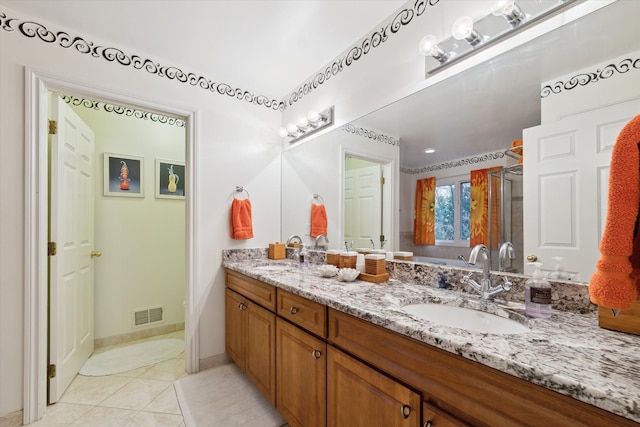 bathroom with tile patterned floors, vanity, and a shower with shower door