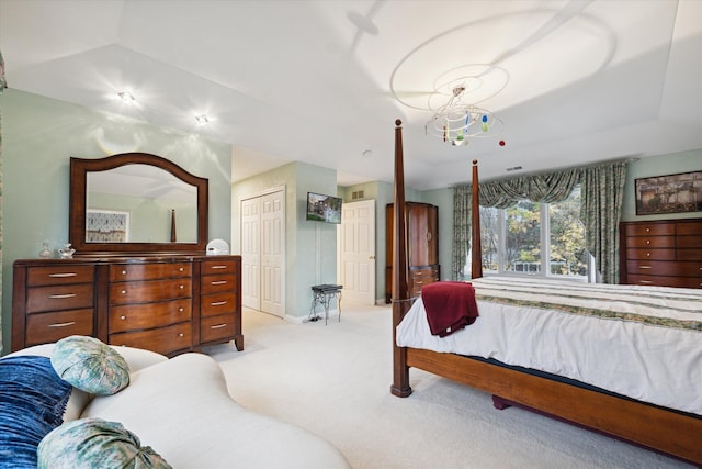 bedroom with light carpet and a closet