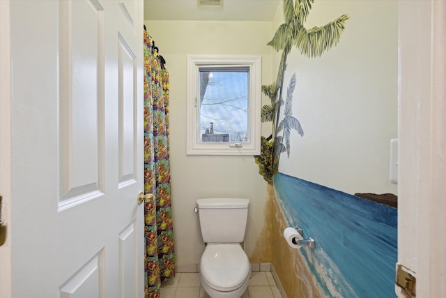 bathroom featuring toilet and tile patterned floors