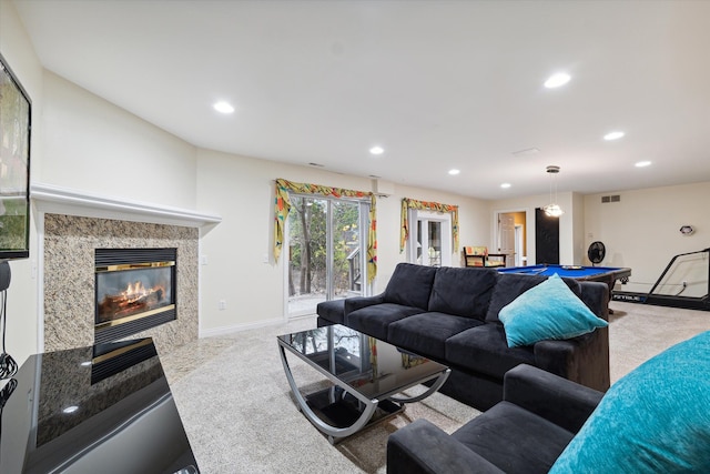 carpeted living room with pool table and a premium fireplace