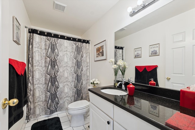 bathroom featuring tile patterned flooring, vanity, and toilet