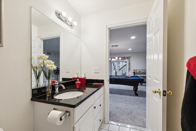 bathroom with tile patterned flooring, vanity, and pool table