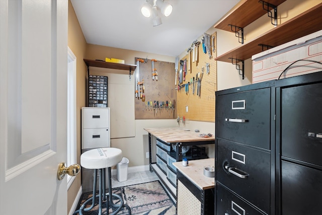 bathroom with tile patterned floors and a workshop area