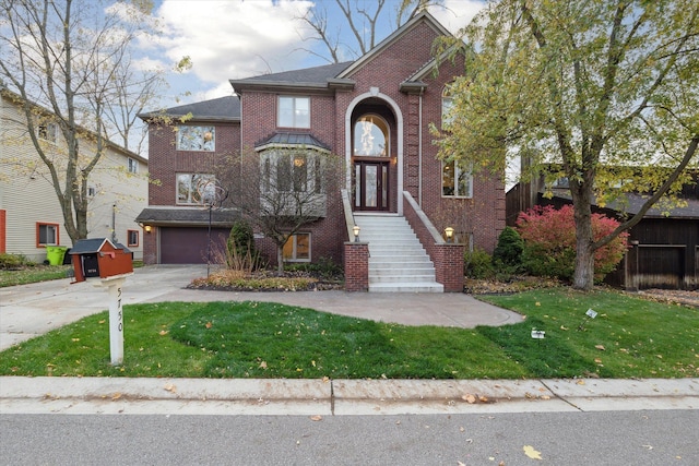 front facade featuring a front lawn and a garage