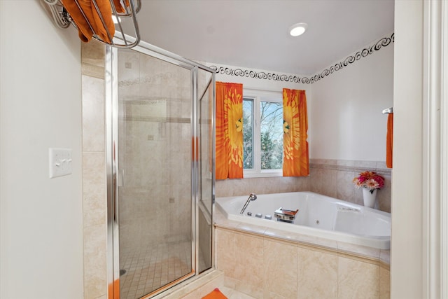 bathroom with shower with separate bathtub