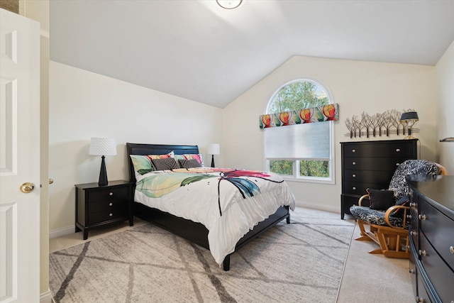 bedroom with light carpet and vaulted ceiling