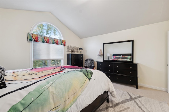 bedroom with light carpet and lofted ceiling