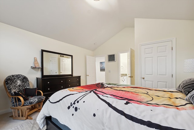 carpeted bedroom with ensuite bath and lofted ceiling