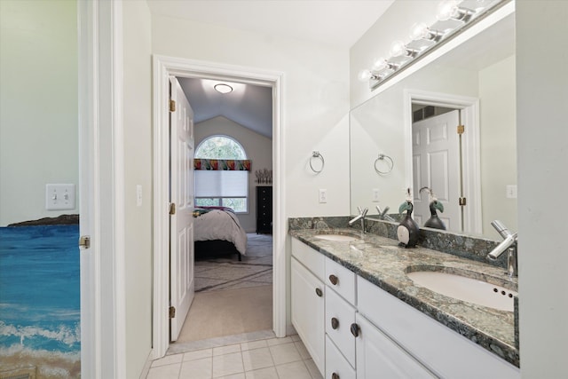 bathroom featuring vanity, tile patterned floors, and lofted ceiling