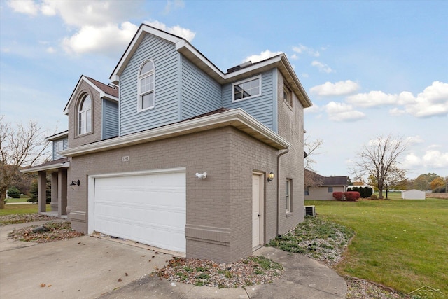 view of side of property featuring a lawn and a garage