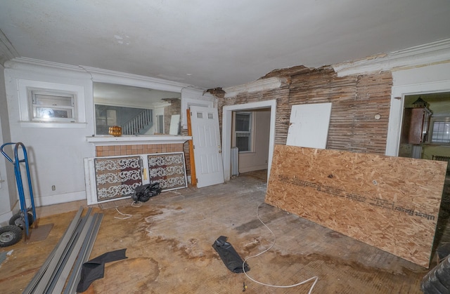 unfurnished living room featuring ornamental molding