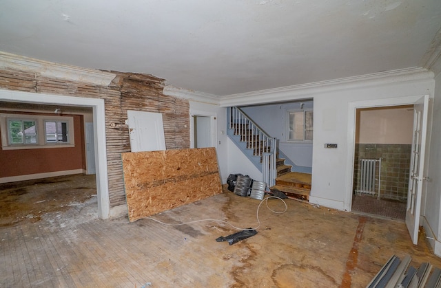 interior space featuring hardwood / wood-style flooring and ornamental molding