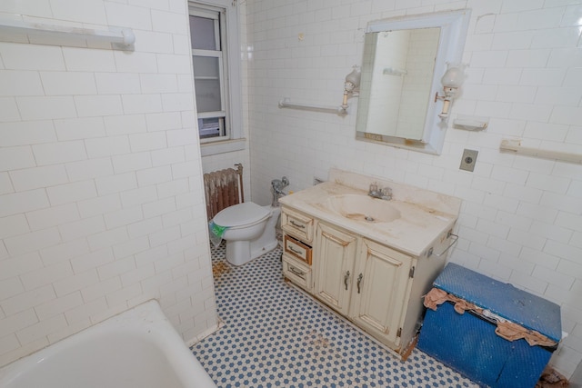 bathroom featuring vanity, toilet, tile walls, and a tub