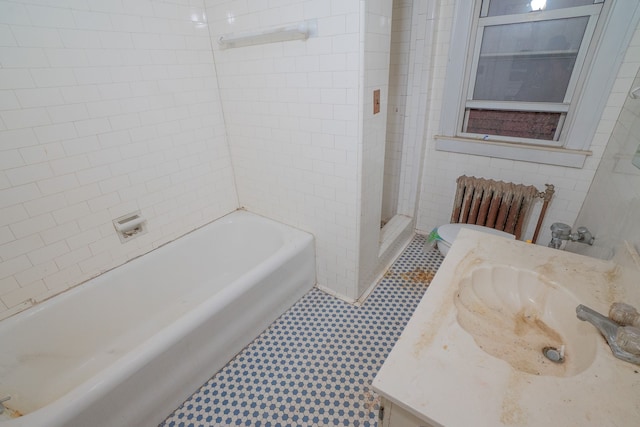 full bathroom with tile patterned flooring, vanity, shower with separate bathtub, and radiator