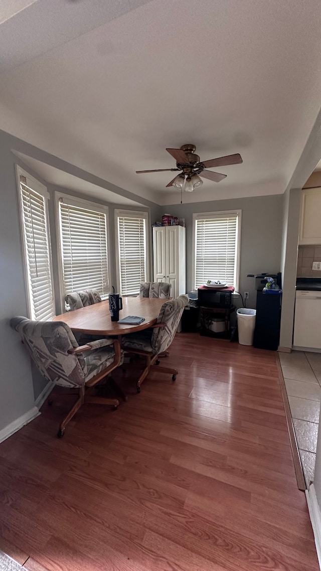 dining room featuring ceiling fan, light hardwood / wood-style floors, and breakfast area