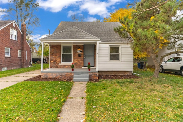 bungalow-style house featuring a porch and a front lawn