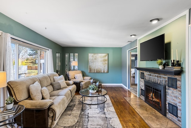 living room with dark hardwood / wood-style flooring and a brick fireplace