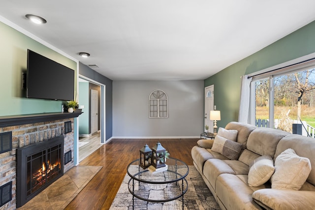 living room featuring a fireplace and dark wood-type flooring