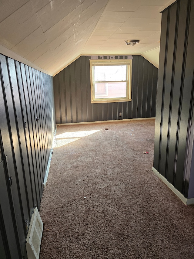 additional living space with carpet flooring and vaulted ceiling