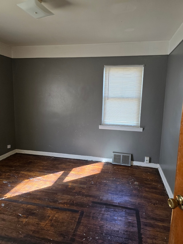 spare room featuring wood-type flooring