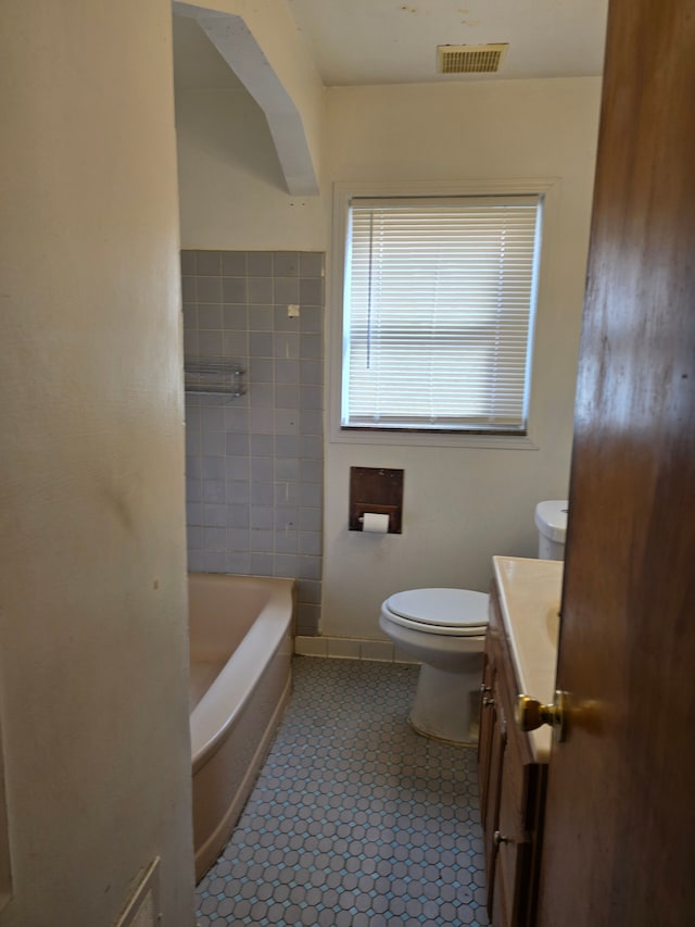 bathroom with tile patterned flooring, vanity, and toilet