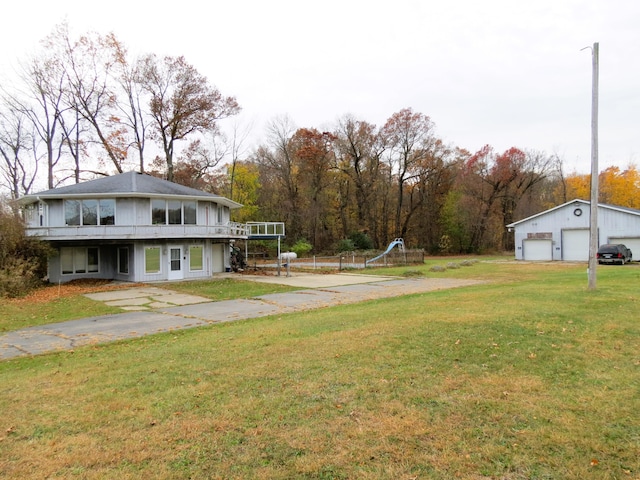 view of yard featuring a balcony and a garage