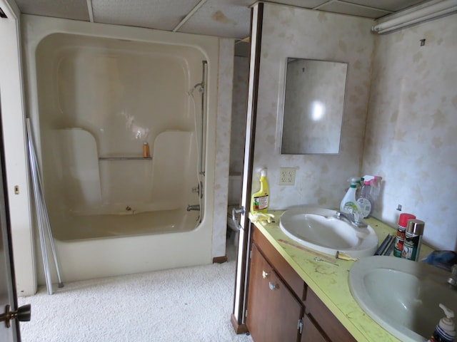 bathroom featuring vanity, a drop ceiling, and tub / shower combination