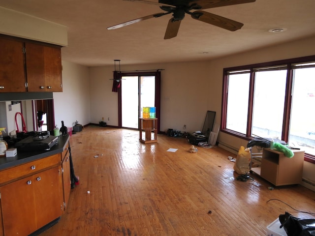 interior space with ceiling fan and light hardwood / wood-style floors