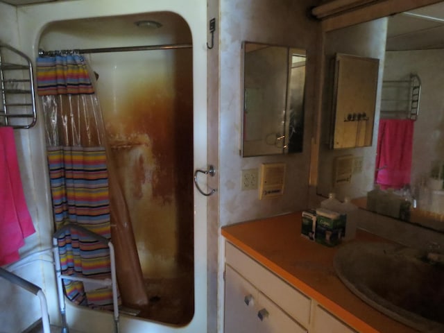 bathroom featuring vanity and curtained shower