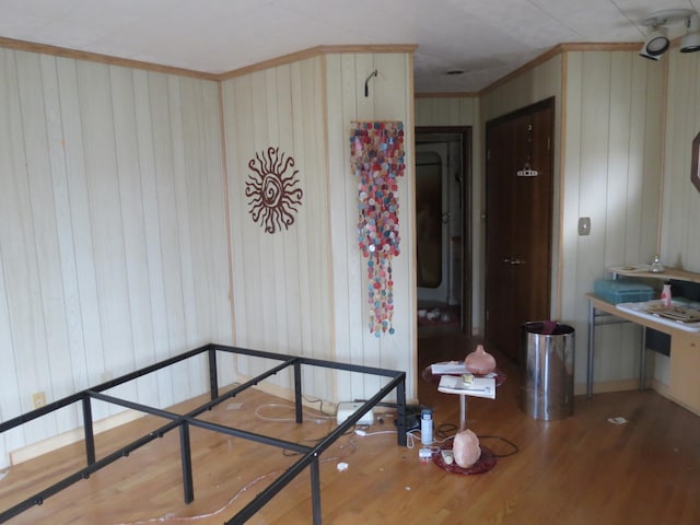 hall with wood walls and light hardwood / wood-style flooring