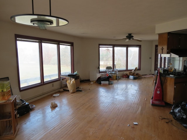 interior space featuring ceiling fan, a healthy amount of sunlight, and light hardwood / wood-style floors