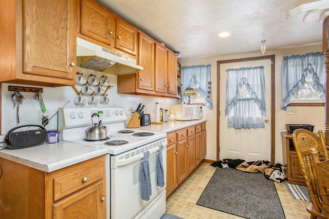 kitchen with white appliances and a textured ceiling