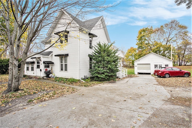 view of side of property with an outdoor structure and a garage