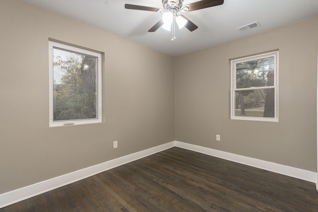 spare room with dark hardwood / wood-style floors and ceiling fan