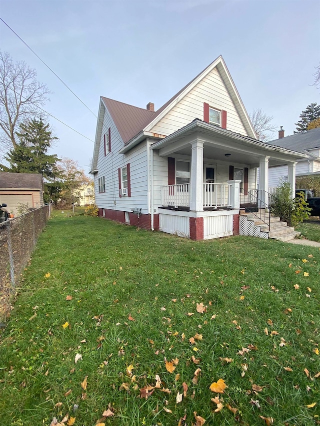 view of front of house with covered porch and a front yard