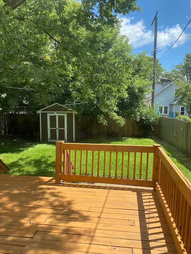 deck featuring a lawn and a storage shed