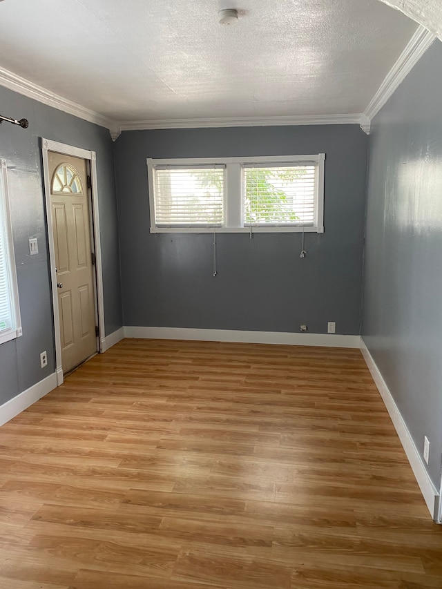 interior space featuring crown molding, a textured ceiling, and light wood-type flooring