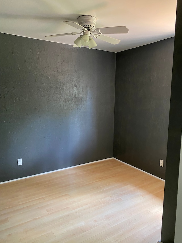 unfurnished room with ceiling fan and light wood-type flooring